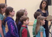 A choir of children, led by Nicole Karalekas (right), sing a song urging the BPA not to put transmission lines near children.
